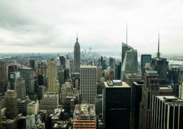 Photography with the title 'NYC Rooftops 8'. Capture of Skyscrapers in Midtown Manhattan overlooking the Empire State Building.