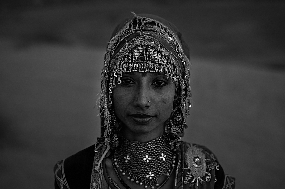 Black and white photography with the title 'India 16'. Portrait of a young Indian woman in a traditional Costume.