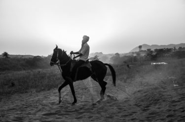 india 21 - black and white portrait of an Indian man riding a horse - photographed by Will Falize - friendmade.fm